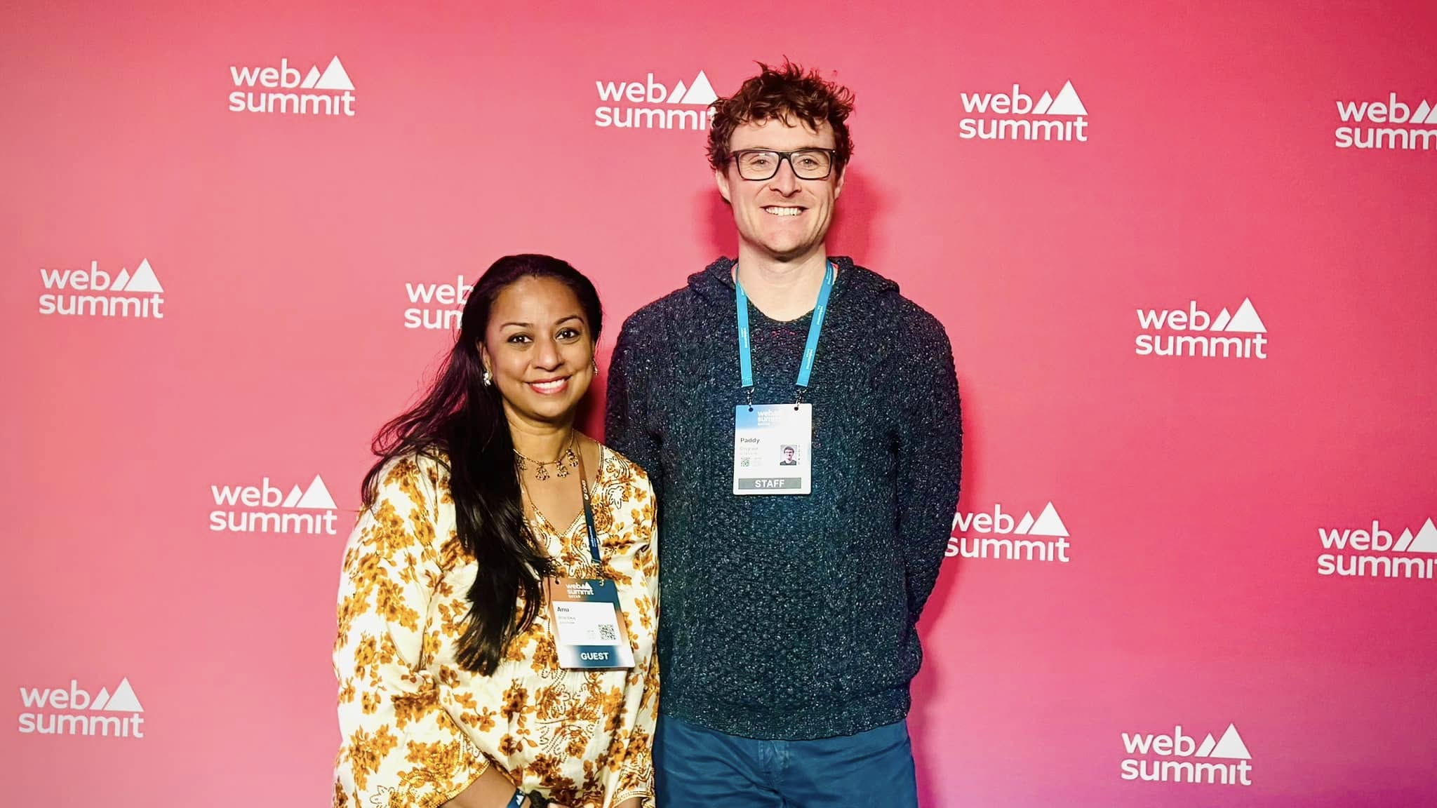 Anu Bhardwaj with Web Summit staff at the official Web Summit Qatar backdrop