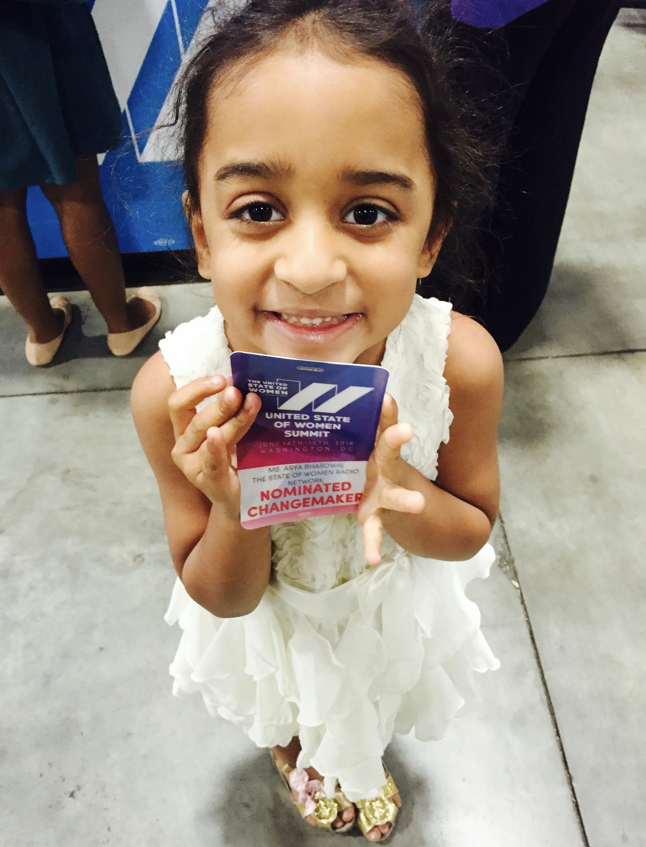 Arya Bhardwaj holding her "Nominated Changemaker" badge — The United State of Women Summit, 2016
