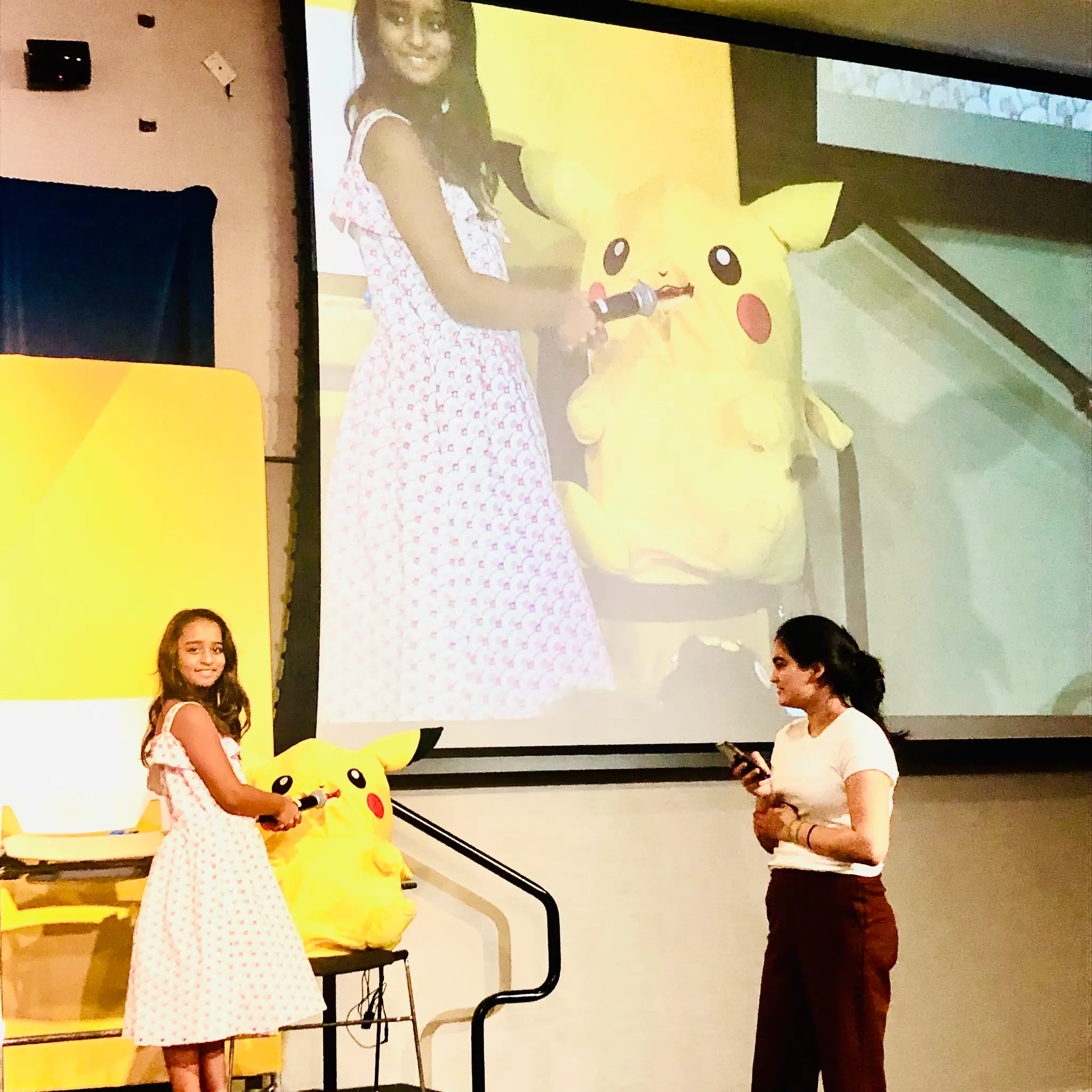 Arya Bhardwaj on stage with a giant Pikachu — CryptoChicks 2019 Youth Track presentation